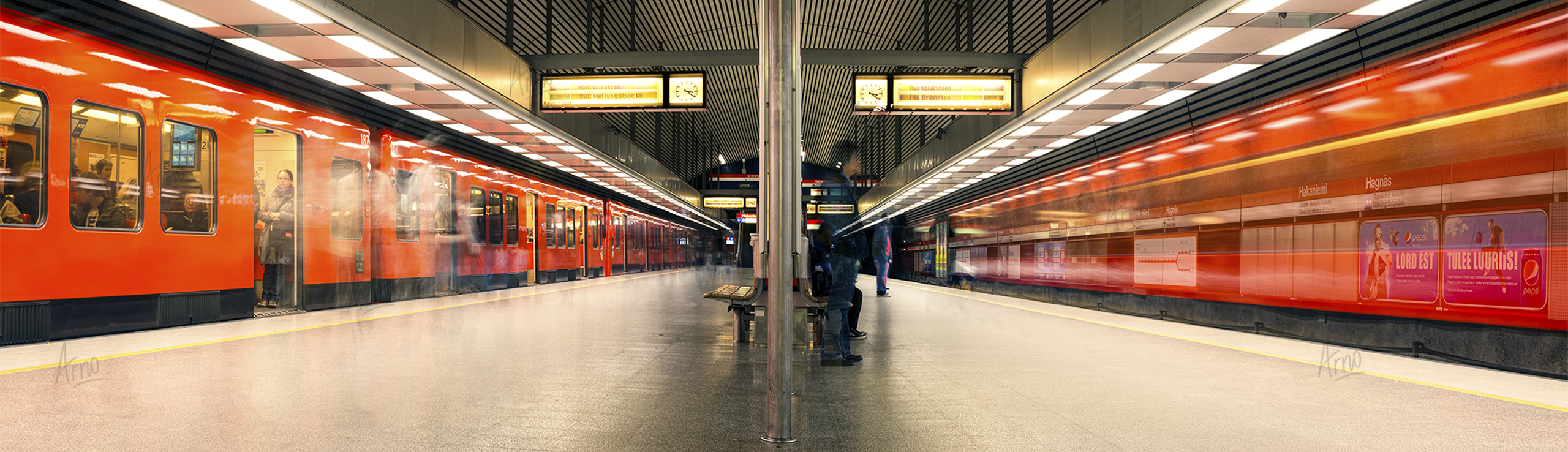 Two subway trains in an underground station at a nearly deserted subway stop