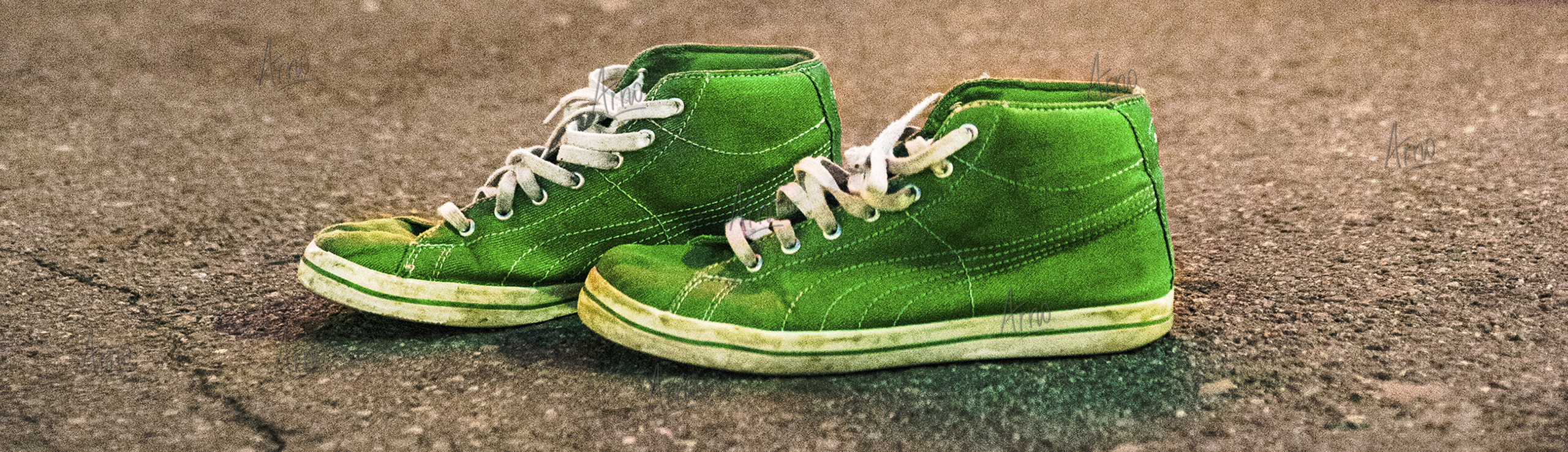 Vivid green pair of sneakers abandoned on the street
