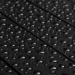 Raindrops on a matte black garden table