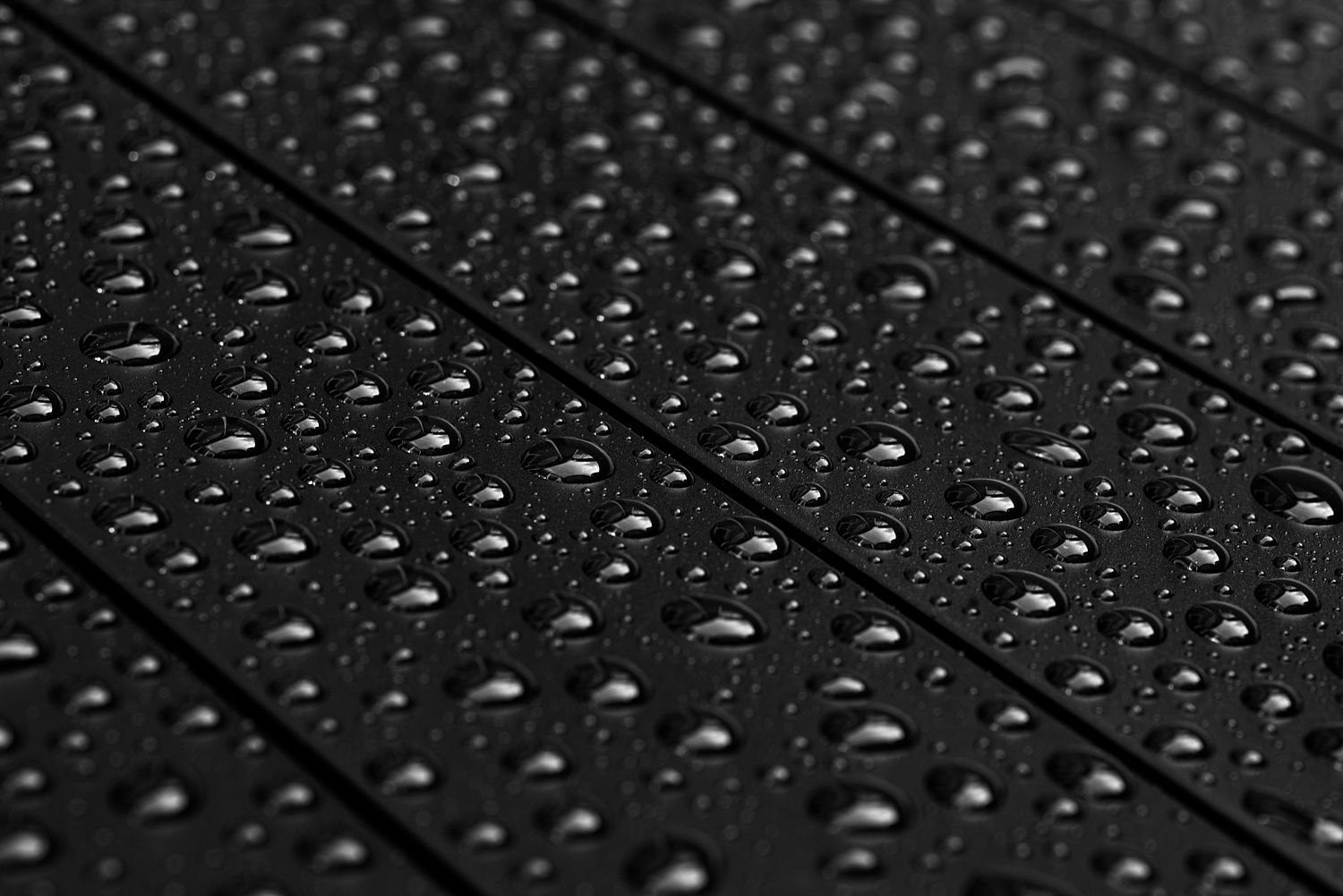 Raindrops on a matte black garden table