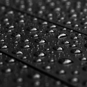 Raindrops on a matte black garden table